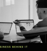 Black and white photo of two people reviewing content on laptops, representing production and shoot turnaround